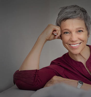 MPC Option 1 Happy Senior Woman On Couch Main Banner Desktop 2500X1635